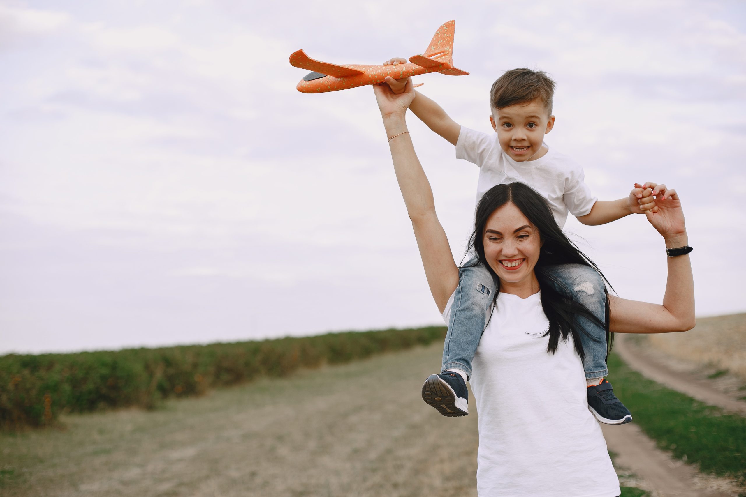 Mother with little son playing with toy plane Mother with little son playing with toy plane